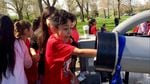 Victor Susunaga Castellanos, a fourth-grader at Westgate Elementary School, puts his hand inside the salmon cannon. The salmon cannon sucks fish up and over obstructions — like dams.
