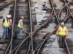 Workers service the tracks at the Metra/BNSF railroad yard in Chicago