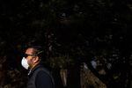 A man wearing a respirator takes a walk Tuesday, April 14, 2020, in Portland, Ore. Local health officials have recommended wearing PPE like masks and gloves to slow the spread of COVID-19.