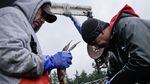Lummi nation fisherman and tribal council member Jeremiah "Jay" Julius (L) and an unidentified colleague harvest crab in Puget Sound off the shore of Cherry Point.