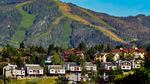 Houses dot the landscape at Colorado's Steamboat Ski Resort on a summer day without a cloud in the sky.