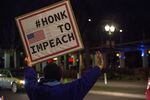 Protesters held up signs along the north end of Tom McCall Waterfront Park, bringing supportive honks from drivers on Naito Parkway on Tuesday, Dec. 17, 2019, in Portland, Ore.