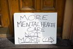 A sign that sits out the entrance of the Cityteam Ministries Shelter reads "More Mental Health Not More Cops."