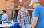 (Left to right) Tyler Woods, Tiffanie Stabler and Steven Wolf talk in the alley behind Origins Faith Community. They work for Malheur County and hand out naloxone, hygiene kits and other supplies during the day shelter’s free meals.