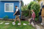 Randal Wyatt, left, shows Annie Moss, right, the accessory dwelling unit built in the backyard of Wyatt’s Albina neighborhood home in Portland, May 9, 2023. Wyatt purchased the three-bedroom home in 2020 from Moss in an off-market sale.