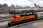 A BNSF engine pull Metra commuter train cars at the Metra/BNSF railroad yard outside of downtown on Sept.13 in Chicago.