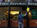 A worker cleans the outside of a First Republic bank in San Francisco.
