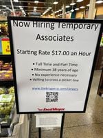 A hiring sign is seen inside a Fred Meyer store.