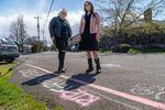Allie Bradley, left, and Dajah Beck, at the intersection where they were both shot while waiting to escort a racial justice march in Northeast Portland in February, 2022. 