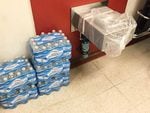 Bottles of water are piled next to a closed drinking fountain at Sabin Elementary School in Northeast Portland.