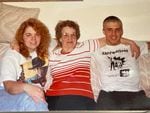 In this undated photo, Erik Banks (right) poses for a photo with his sister Jen McGill, left, and their grandmother. Banks is wearing a T-shirt from a white supremacist band, Skrewdriver.