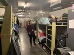 Stacy Borke, the senior director of programs for Transition Projects Inc., looks at the beds in Doreen’s Place, a shelter in downtown Portland. The county has asked shelters to try and create a six foot buffer around the beds of sick guests.