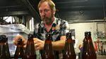 Double Mountain Brewery founder Matt Swihart grabs freshly bottled pale ale from the bottling line in Hood River. The brewery's new beer is among the first to be sold in Oregon's new refillable beer bottles.