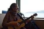 Julienne Battalia, one of the pipeline protesters who traveled from Washington to British Columbia to join a march opposing expanding oil transport through the Salish Sea. She and others in her group sang about the sea, which is shared by Washington and BC, while taking a ferry ride to Victoria.