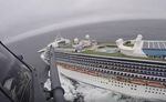 In this image from video, provided by the California National Guard, a helicopter carrying airmen with the 129th Rescue Wing flies over the Grand Princess cruise ship off the coast of California Thursday, March 5, 2020. Scrambling to keep the coronavirus at bay, officials ordered a cruise ship with 3,500 people aboard to stay back from the California coast Thursday until passengers and crew can be tested, after a traveler from its previous voyage died of the disease and at least two others became infected.