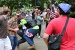In 2017, Tusitala “Tiny” Toese, center, a known member of the militia style group, the Oath Keepers, was photographed tackling an Antifa protester before federal law enforcement officers detained the protester and arrested him. 
