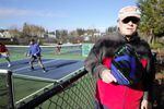 Retiree Doug Vokes holds his pickleball paddle next to a court at Tanner Creek Park in West Linn, Ore., on Feb. 10. 2023. 