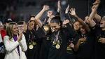Portland Thorns forward Sophia Smith holds the MVP trophy after the team's NWSL championship soccer match against the Kansas City Current, Oct. 29, 2022, in Washington. At left is NWSL Commissioner Jessica Berman.