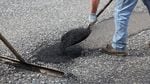 An ODOT maintenance crew fills potholes on Highway 26.