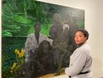 Sadé DuBoise with her painting The Collective Mourn, which was part of the Jordan Schnitzer Museum of Art's Black Lives Matter exhibition in spring 2022.