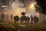 Tear gas fills the air during protests, Friday, Sept. 18, 2020, in Portland, Ore. The protests, which began over the killing of George Floyd, often result frequent clashes between protesters and law enforcement.