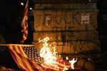 Protesters burn an American flag in downtown Portland on the 4th of July. Hundreds of protesters gathered at the Justice Center and federal courthouse before Portland Police and federal law enforcement used tear gas and impact munitions to disperse the crowd.