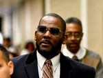 Musician R. Kelly (center) was found guilty Wednesday on three counts of child pornography but was acquitted of a conspiracy to obstruct justice charge accusing him fixing his state child pornography trial in 2008.