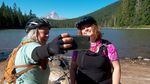 Marley Blonsky, left, and Kailey Kornhauser of All Bodies on Bikes take a selfie at Frog Lake near Mount Hood. The popularity of their group has made them social media influencers.