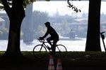 A biker rides through the Tom McCall Waterfront Park in Portland, Oregon, on Sept. 24, 2019.
