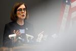 Gov. Kate Brown speaks at a press conference on March 16. Brown announced she is closing the state’s bars and restaurants and banning gatherings of more than 25 people.