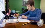 Imaan Mohandessi, 18, completes schoolwork at his home in Vancouver, Wash., March 12, 2021. Imaan attends Seton Catholic College Preparatory High School, where they recently invited seniors to return to the school.