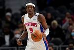 FILE - Detroit Pistons forward Jerami Grant brings the ball up against the Minnesota Timberwolves during the second half of an NBA basketball game in Detroit, Feb. 3, 2022. A person with knowledge of the move said the Pistons agreed Wednesday, June 22, to trade Grant to the Portland Trail Blazers.