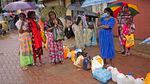Women, several holding umbrellas, wait in a queue to buy kerosene in in Colombo, Sri Lanka, Saturday, June 11, 2022.
