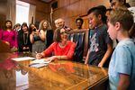 In this June 30, 2015 photo, Oregon Gov. Kate Brown is seen signing House Bill 3499. Monday, Dec. 14, the governor announced her intentions to add a new member to her administration who will be tasked with finding a fix for the state's low graduation rate.