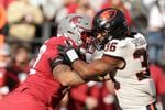 Washington State offensive lineman Abraham Lucas, left, blocks Oregon State linebacker Omar Speights during the second half of an NCAA college football game, Saturday, Oct. 9, 2021, in Pullman, Wash.