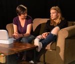 Playwright Mikki Gillette wrote "American Girl," a play about Nikki Kuhnhausen, a trans teen from Vancouver who was killed in 2019. Naomi A. Jackson, seated on the right, portrays Nikki Kuhnhausen in the play, which also features Maia McCarthy in the role of Lisa Kuhnhausen, Nikki's mother.