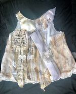 A tattered and resewn garment from artist Judy Hoiness' series of little girls' dresses.