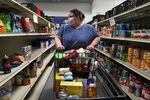 Heather Thomas browses the aisles of the Western Fairfax Christian Ministries food pantry in Chantilly, Va., last month.