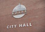A sign on a brick wall says Boise City Hall.