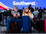 John and Lori Ingoldsby, who drove to Denver after the first leg of their flight on Southwest Airlines was canceled, wait for a flight to finish their trip at Denver International Airport on December 28, 2022 in Denver, Colorado.