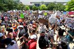 Protesters hold a rally in Discovery Green Park, across the street from the National Rifle Association's annual meeting held at the George R. Brown Convention Center on Friday, May 27, 2022 in Houston.