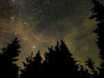 A meteor streaks across the sky during the annual Perseid meteor shower in August 2021 in West Virginia.