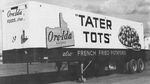 A black-and-white image of an Ore-Ida Foods tractor trailer with the company logo and the word "Tater Tots" on the side.