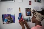Azaysha looks at ribbons pinned to the wall of her room in Portland, Ore., Wednesday, May 22, 2019. Azaysha's wall includes photos of her family, a drawing a friend made of her, photos of her favorite band, and her first report card with letter grades.