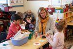 Kendra Coates sits with kindergarteners at Redmond Early Learning Center