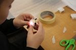 A Tumalo Community school student prepares a light he programmed to go into a student-designed product. 