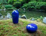 A ceramic statue by Jun Kaneko is nestled into a corner of the garden as part of the exhibition, "Garden of Resonance."