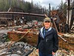 Jamee Savidge, outside the remnants of several Blue River businesses including the gas station.