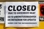 A "closed due to excessive heat" sign is posted outside a Portland food cart.
