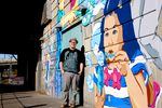 Alex Chiu stands by his mural at the platform of the 82nd Avenue Max Train Station.